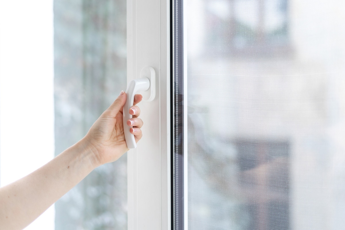 Hand closing a window