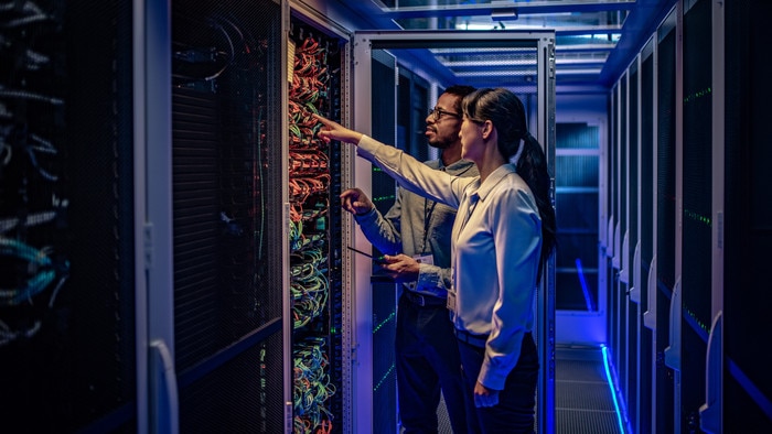 IT engineers checking servers in server room or data center