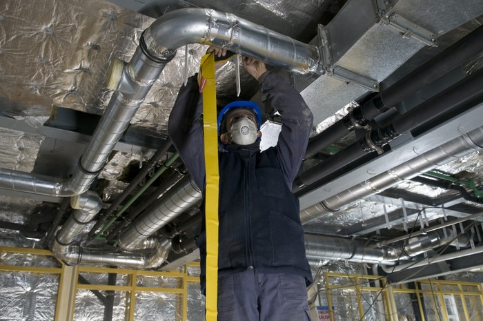 Technician working on an HVAC air duct
