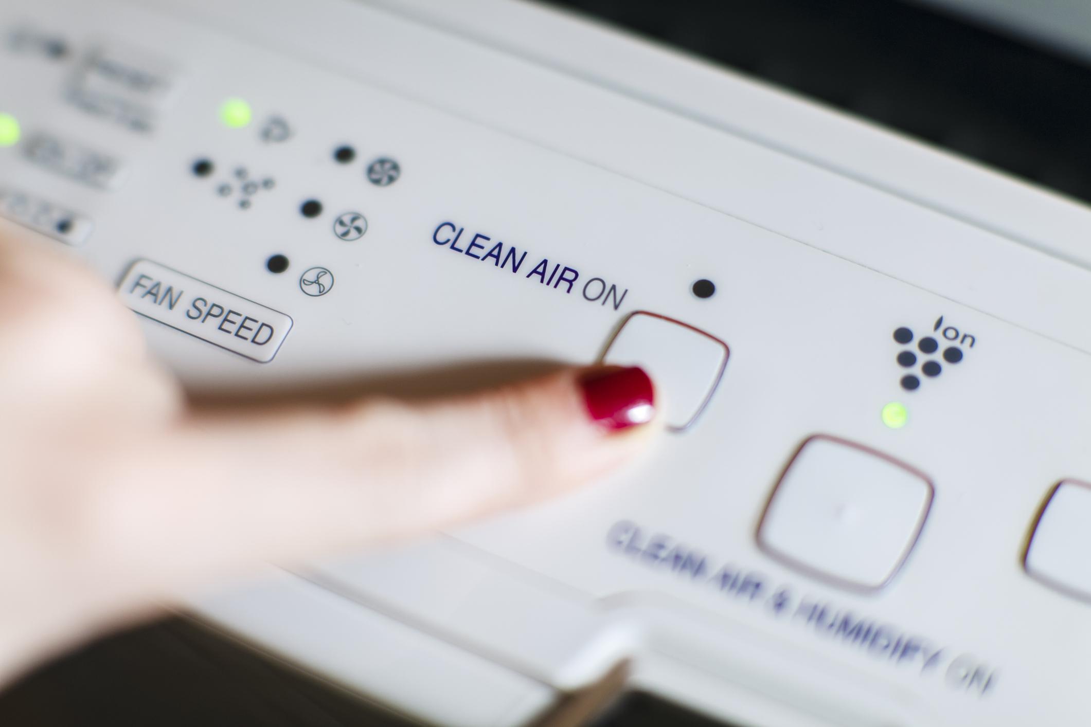 Turning On Modern Air Purifier And Ionizer
